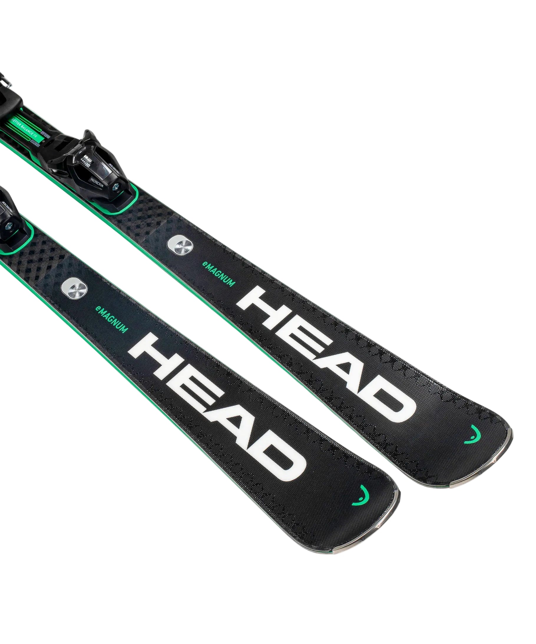 Two black Head skis with green accents on a white background