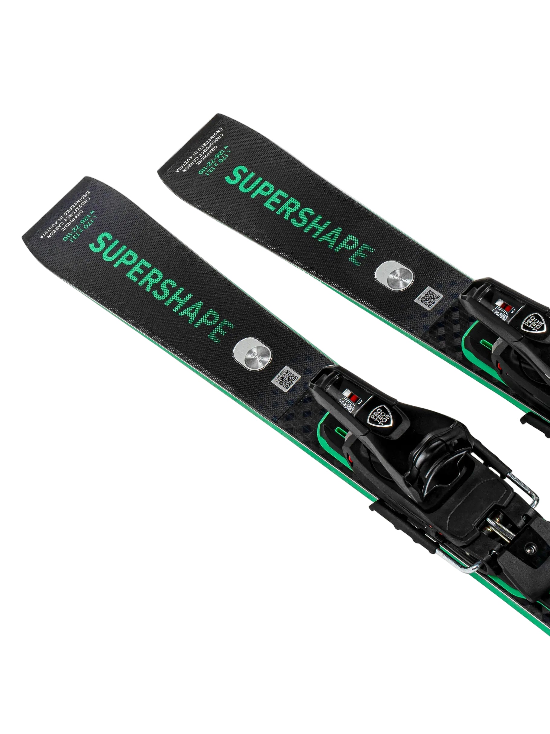 Two black and green skis with bindings on a white background